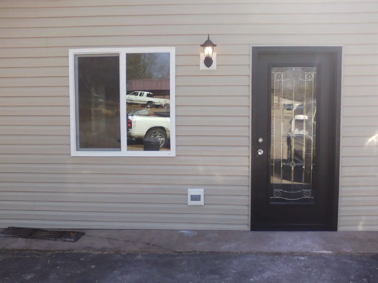 New siding, window and entry door on the side of an addition in Waverly